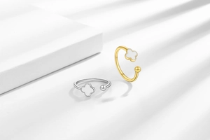 Detail of minimalist clover rings in gold and silver finish with mother of pearl inlay