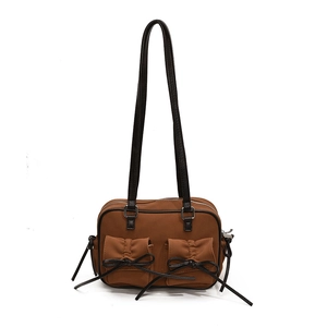 Retro brown nylon shoulder bag with black bow details and pleated pockets on white background