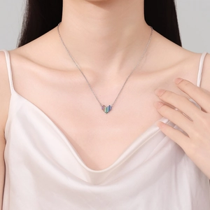 Elegant rainbow heart pendant necklace with zircon stones on a female model