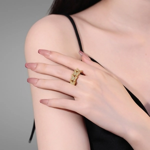 Double-layered golden butterfly ring with sparkling zircons worn by a model