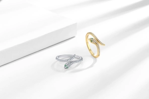 Macro detail of multi-layer snake rings with 18K gold and silver zircon micro-paving