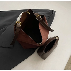 Top view of faux suede bucket bag with inner pouch and gold-tone hardware details