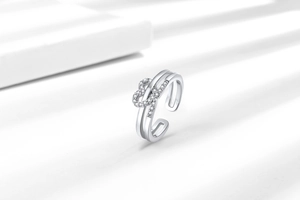 Macro shot of silver double-layered ring with sparkling zirconia infinity heart symbol