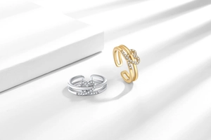 Detail view of double-layered heart rings with micro-inlaid cubic zirconia in gold and silver