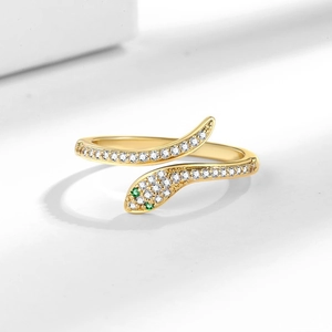 Elegant multi-layer gold snake ring with white zircon pave and green gemstone eyes