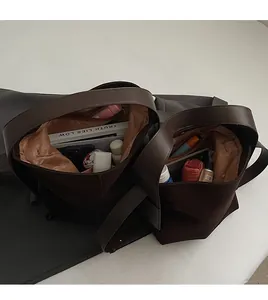 Top view of spacious bucket bag interior showing organized books and essentials
