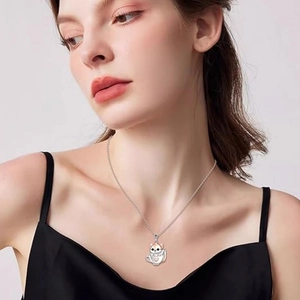 Cute white cat in a teacup pendant necklace with rose gold accents on a model