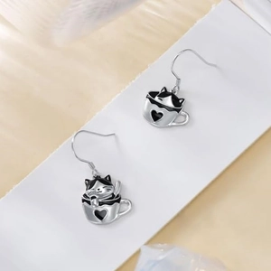 Asymmetric cat in coffee cup dangle earrings with heart motif and silver hooks