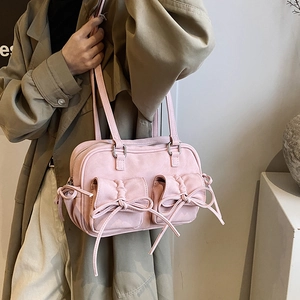 Chic pink shoulder bag with bow details and front pleated pockets for women