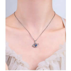 Blue planet necklace with silver Saturn ring pendant featuring pavé crystals on model