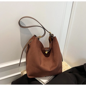 Brown suede shoulder bucket bag with adjustable strap and gold buckle for women