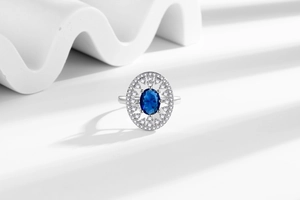 Detailed view of luxury oval sapphire ring with zircon accents on geometric prop