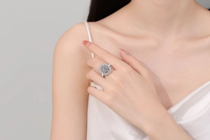 Close-up of a luxury halo zircon ring with snowflake design worn on a finger