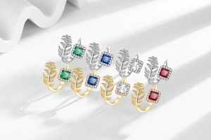 Macro detail of leaf-shaped rings with colorful square zircon stones and 18K gold plating