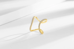 Detail of 18k gold plated double curve ring with sparkling crystals and elegant shadows