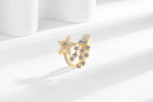 Macro shot of gold star and meteor ring showing detailed sparkling pavé zircon setting