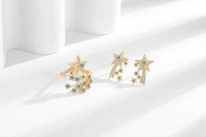 Detailed view of gold-plated shooting star jewelry set with pavé-set white zircons