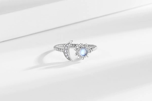 Detailed close-up of moon and sun open ring with pavé crystals and moonstone element