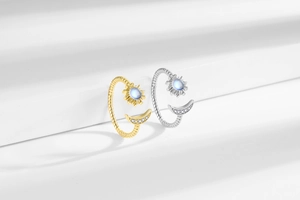 Detailed close-up of sun and moon open rings with moonstone and pavé zircon settings