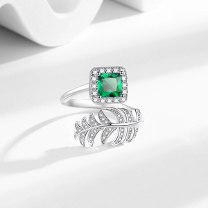 Adjustable sterling silver ring with square green gemstone and zircon-studded feather