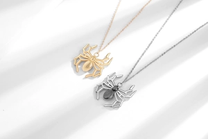 Detailed close-up of gold and silver spider pendants with intricate punk textures and shadows