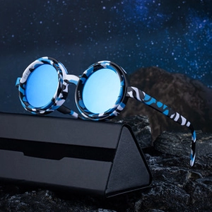 Detail of round polarized camo sunglasses on a black case with blue reflective lenses