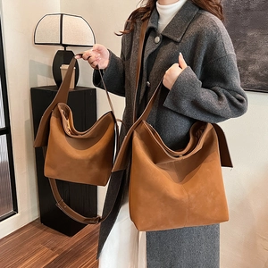 Brown minimalist bucket shoulder bags in large and medium sizes made of suede leather