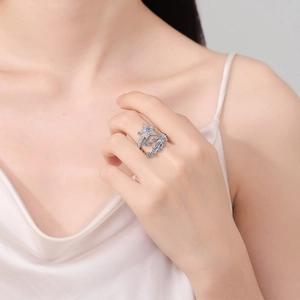 Fashion meteor ring with blue and white crystals on model hand, adjustable silver band