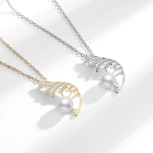 Elegant feather pendant necklace in gold and silver finish with pearl and crystals