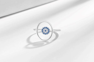 Macro detail of silver adjustable ring with blue and white pavé cubic zirconia evil eye