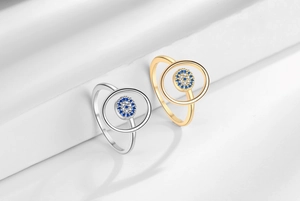 Detail view of adjustable evil eye rings with blue crystals in gold and silver finish