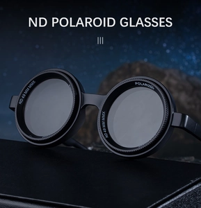 Close-up of polarized round sunglasses with 49mm lens markers on dark rock texture
