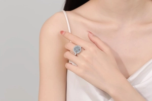 Macro shot of silver rotating clover ring with zircon inlay worn by model on hand