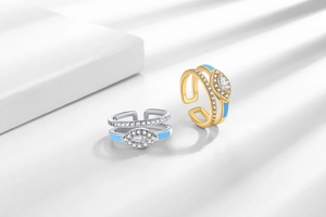 Detailed close-up of multi-layer evil eye rings with blue enamel and zircon inlay
