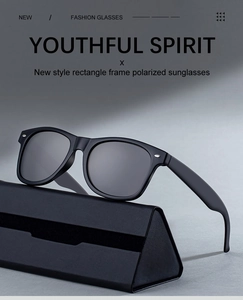 Close-up of matte black rectangular polarized sunglasses with silver rivets and folding case