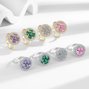 Rotating four-leaf clover anxiety rings in gold and silver with colorful crystal hearts