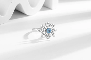 Detailed macro view of silver evil eye spinning ring with bright blue zircon stone