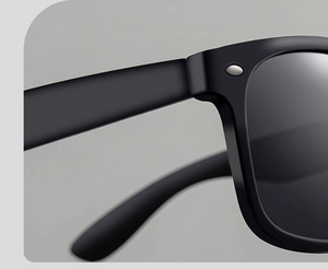 Detail shot of black matte square frame hinges with silver metal oval rivet accents