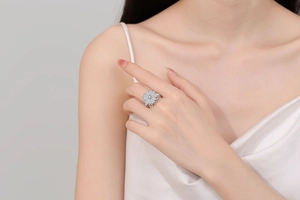 Macro detail of a spinning clover flower ring with shimmering zircons on silver band