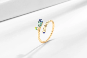 Detail of leaf ring showing green enamel flower bud and golden vine texture