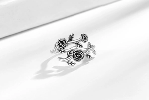 Macro shot of retro silver rose and leaf ring with vintage oxidized finish details
