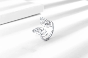 Macro shot of 925 sterling silver open ring with hollow butterfly wing filigree detail