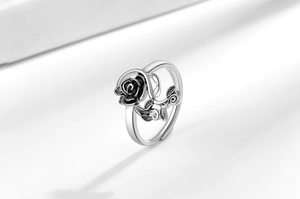 Macro detail of vintage silver rose ring with oxidized floral textures and adjustable band