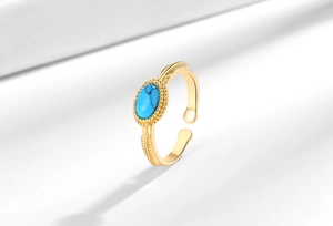 Macro view of vintage adjustable ring with turquoise stone and ornate gold engraving