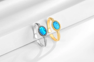 Detailed close-up of retro silver and gold rings with blue turquoise stones and engravings