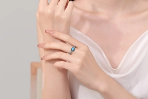 Detail shot of vintage silver ring with oval turquoise stone and woven texture