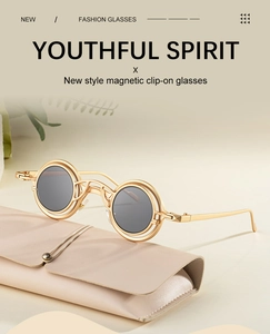 Detail of round magnetic clip-on sunglasses with metal frames and beige leather case