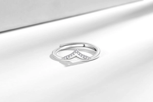 Macro view of silver V-shaped open ring with pavé micro-inlaid white zircons