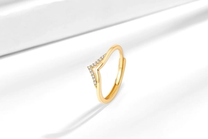 Detailed view of gold V-shaped ring featuring sparkling pave cubic zirconia accents