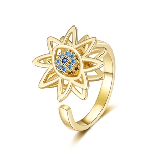 Rotating devil eye ring with gold star petals and blue crystal center in open design